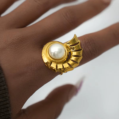 Bague Coquillage Conque Incrusté sur le doigt d'une femme