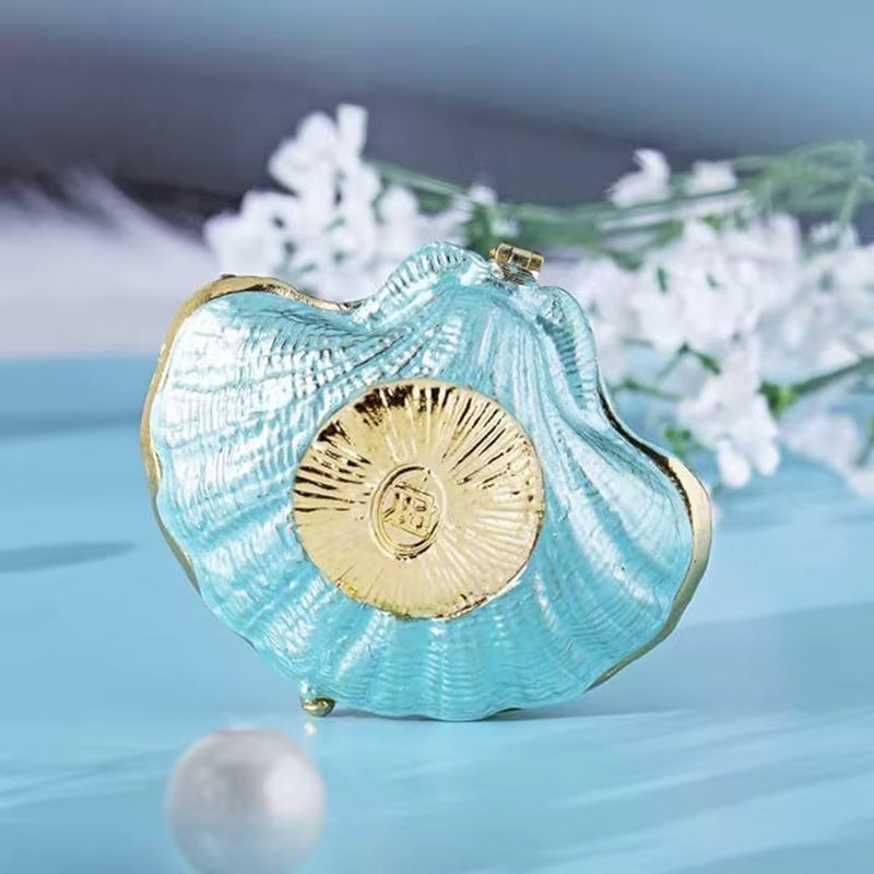 Boîte à Bijoux Coquillage Brillante et Design sur fond bleu