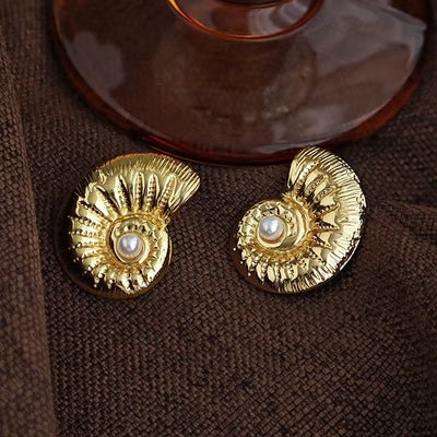 Boucle d’Oreille Coquillage Conque en Acier Inoxydable sur fond marron